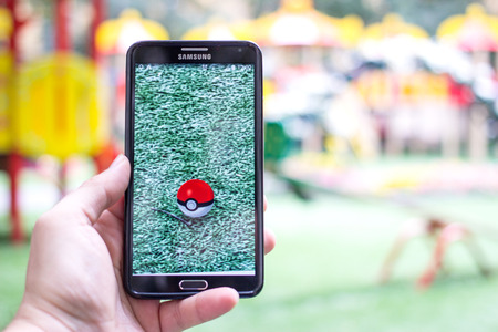 AUG 03, 2016 MOSCOW, RUSSIA: Pokemon Go gameplay screenshot on the phone. Pokebol on mobile phone screen. Pokemon Go is a modern location-based augmented reality mobile game.のeditorial素材