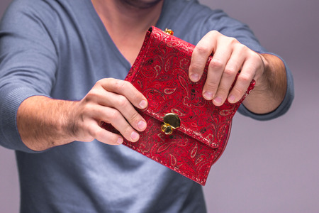 Modern red leather bag in male handsの写真素材