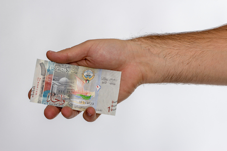 Kuwaiti dinar banknote in hand. Kuwaiti dinar is the national currency of Kuwait