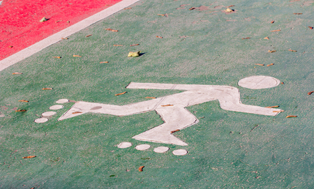 Markings of the roller on asphalt with fallen leavesの写真素材