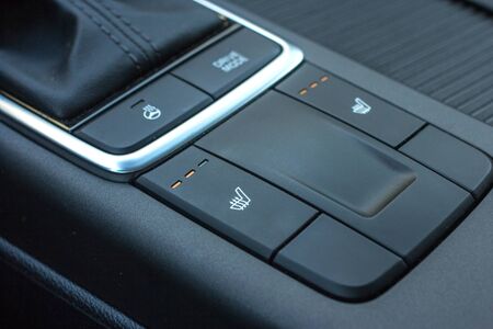 Close up shot of modern car central console with seat and steering heating controls