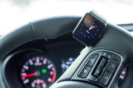 Modern car interior with smart watch in steering wheelの写真素材