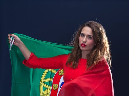 Beautiful brunette woman with Flag of Portugal. Toned image.の写真素材