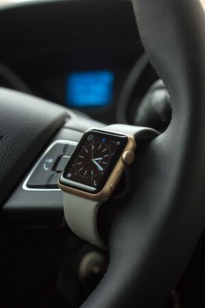Modern car interior with smart watch on steering wheelの写真素材