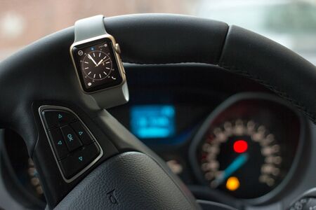 Modern car interior with smart watch on steering wheelの写真素材