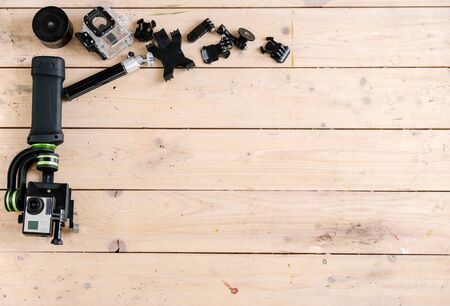 Active Camera and On Table and accessories set. Wooden Background. Studio Shotの写真素材