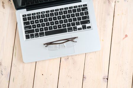 Business Still Life Concept. Glasses on modern laptop.の写真素材