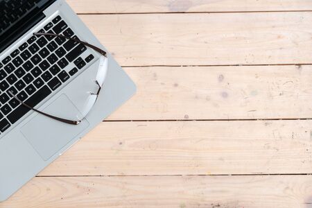 Business Still Life Concept. Glasses on modern laptop.の写真素材