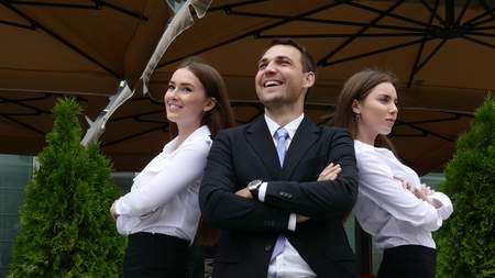Group of confident professional managers standing in front of officeの写真素材