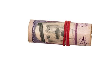 Rolled Saudi Arabian Riyal banknotes with a rubber ring, isolated on white.