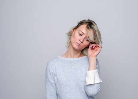 Adult sad woman posing in studio. Negative emotions..