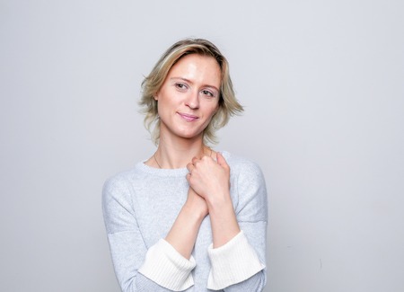 Adult tenderness woman posing in studio. Positive emotions. Tenderness.の写真素材