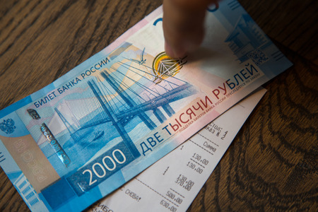 Man put finger on New 2000 rubles banknote in  in cafe.の写真素材
