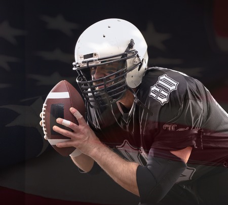 Close up portrait of American Football Player posing in studio wearing violett uniform with US flag...