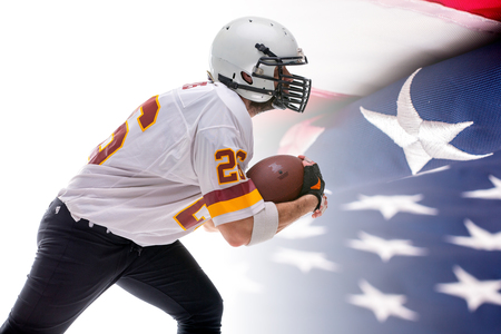 Bearded American football player in white uniform, in action, isolated on US flag background.の写真素材