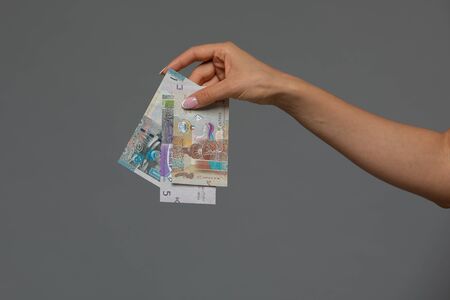 Kuwaiti dinar banknote in hand of young woman. Kuwaiti dinar is the national currency of Kuwaitの写真素材