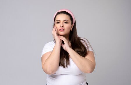 Plus size woman with pink hair rim. Positive human facial expressions and emotionsの写真素材