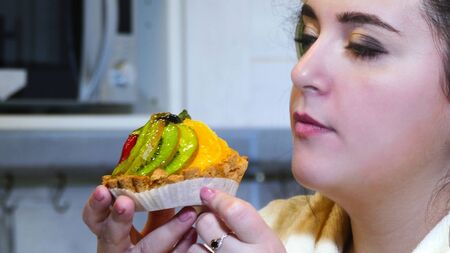 To eat or not to eat is a difficult choice for overweight womanの写真素材