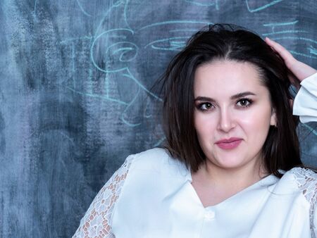 Charming girl in national Slavic clothes on a slate background, close up portrait