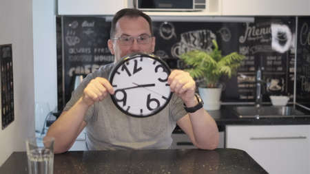 Man holding a clock