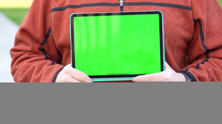 Man holding Tablet computer with green screen and chroma key.の写真素材