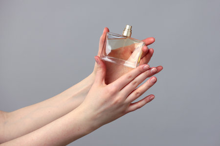 Perfume bottle in beautiful woman handsの写真素材
