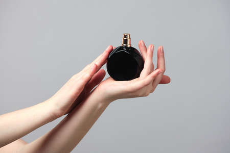 Perfume bottle in beautiful woman handsの写真素材