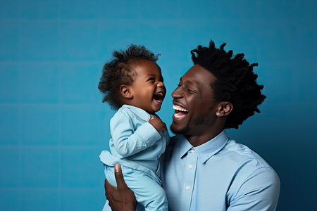 African-american father and son portrait on gradient studio background in neon. Beautiful male models in casual style, white shirt. Concept of human emotions, facial expressionの素材