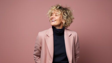 Confident mature woman with crossed arms in casual clothing with copy space. Successful smiling woman with big grin looking at camera. Beautiful positive businesswoman standing against pink backgroundの素材