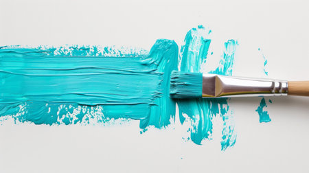 Paintbrush with dripping aqua blue paint isolated over white backgroundの素材