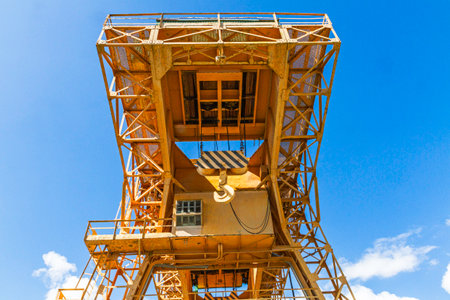 Detail of a construction crane against the blue sky. Industrial background.