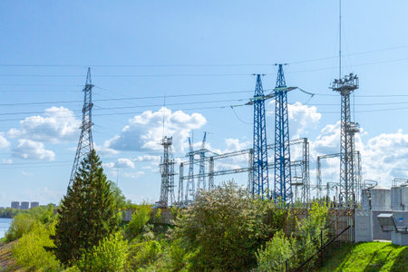 Electrical substation with power line supports on a sunny day.