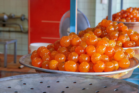 Close-up of traditional French candied mandarin dessert on metal trayの写真素材