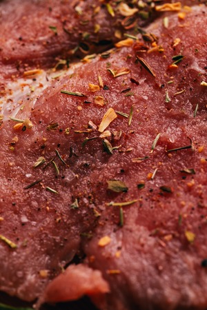 raw meat pepper on a wooden light background.の写真素材
