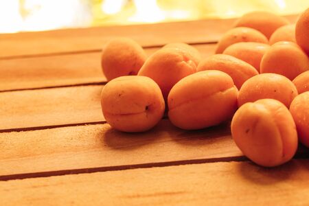 fresh ripe orange apricot closeup on wooden background.の写真素材