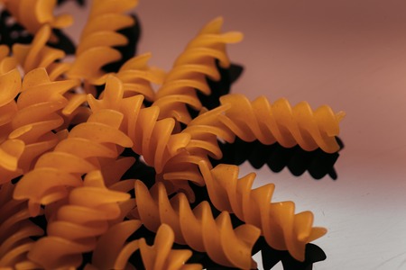 many macaroni scattered on a black background.の写真素材