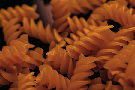 many macaroni scattered on a black background.の写真素材