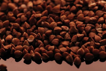 many buckwheat scattered on a black background.の写真素材