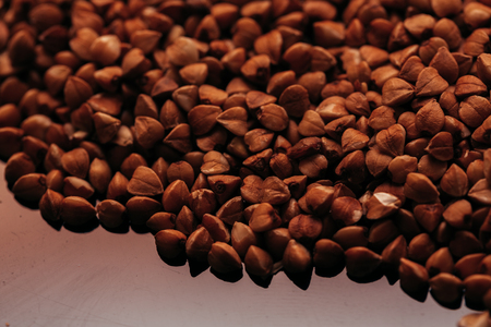 many buckwheat scattered on a dark mirror background.の写真素材