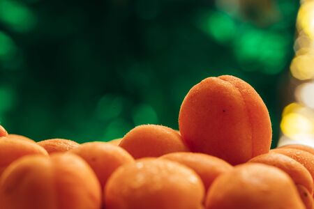 Fresh ripe apricots closeup on the blurry green wooden background.の写真素材