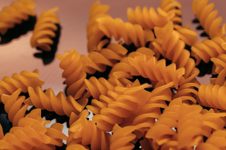 many macaroni scattered on a black background.の写真素材