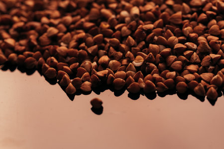 many buckwheat scattered on a black background.