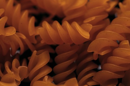 many macaroni scattered on a black background.の写真素材