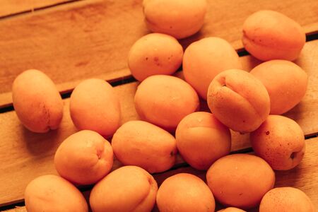 fresh ripe orange apricot closeup on wooden background.の写真素材