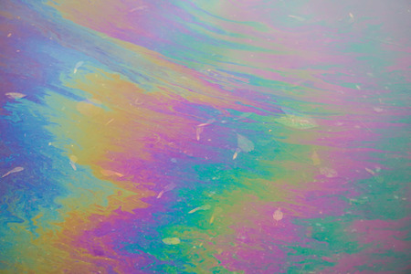 Rainbow puddle after spilled gasolineの写真素材