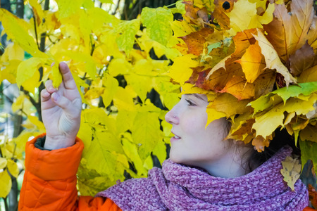Autumn girl with maple leavesの写真素材