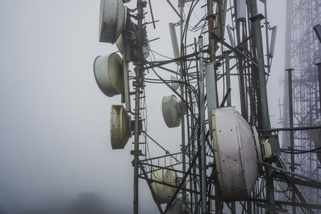 Tower with radio antennas in the fog. Tiger Hill near the town of Darjelling. India