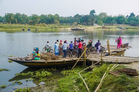 Mayapur, India - April 4, 2017: Local Indians are ferried by raftのeditorial素材