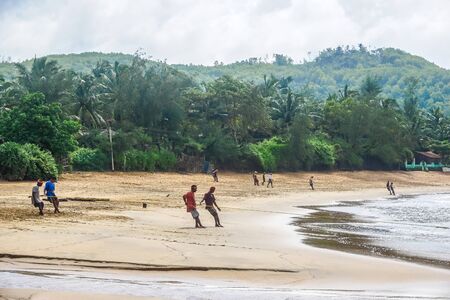 Gokarna Village, Karnataka State, India - July 31, 2017: Indian men catch fish using a long net. It is very hard.のeditorial素材