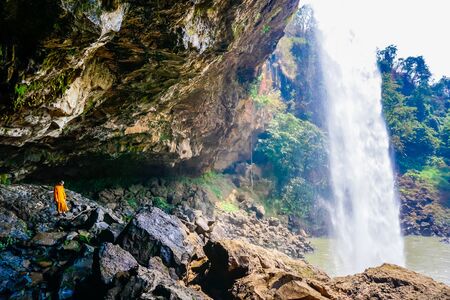 Monk under the Phu Chong waterfall in Vietnamの写真素材